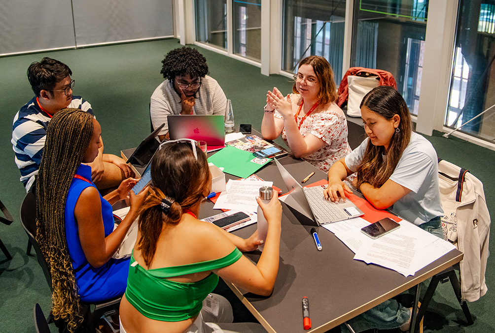 Six students working together around a table