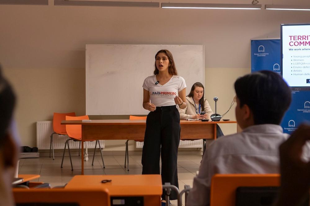 Student presenting in front of a classroom
