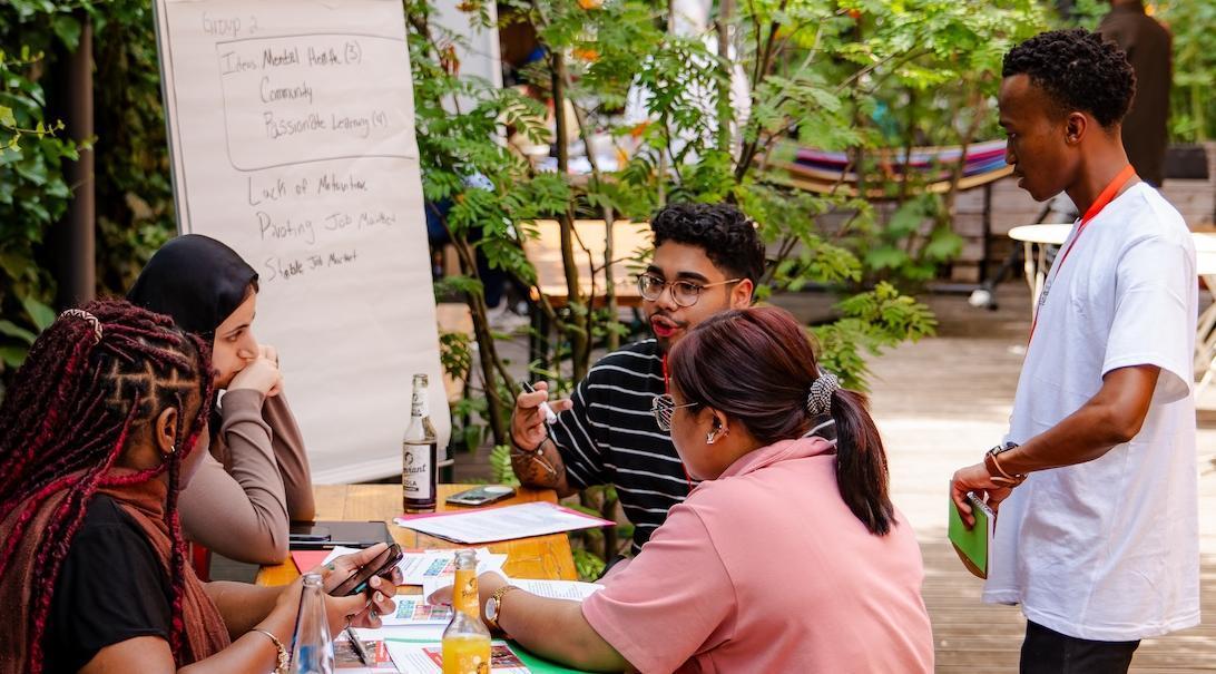 Group of students studying together outside 